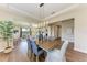 Open concept dining room with wood floors and view into the living area at 4789 Vasca Dr, Sarasota, FL 34240