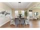 Elegant dining room featuring wood floors, tray ceiling, and stylish lighting fixture at 4789 Vasca Dr, Sarasota, FL 34240