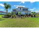Charming two-story home boasting an appealing facade, meticulously manicured landscaping, and mature palms at 4789 Vasca Dr, Sarasota, FL 34240