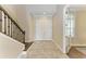 Bright and airy foyer with tile flooring, staircase, and natural light from window at 4789 Vasca Dr, Sarasota, FL 34240