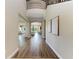 Spacious hallway with hardwood floors and an open view into the living room at 4789 Vasca Dr, Sarasota, FL 34240