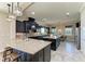 Gourmet kitchen with dark cabinets, granite counters, island and stainless steel appliances at 4789 Vasca Dr, Sarasota, FL 34240