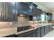 Modern kitchen featuring granite countertops, stainless steel appliances, and dark wood cabinetry at 4789 Vasca Dr, Sarasota, FL 34240