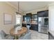 Kitchen nook with a round table and seating with decorative chandelier and stainless steel refrigerator at 4789 Vasca Dr, Sarasota, FL 34240