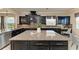 Open kitchen with granite countertops and island with stainless steel appliances and view to the outside at 4789 Vasca Dr, Sarasota, FL 34240