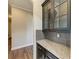 Kitchen nook with granite counters, hardwood floors and dark wood cabinetry at 4789 Vasca Dr, Sarasota, FL 34240