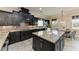 Modern kitchen featuring granite countertops, dark cabinetry and an island, perfect for cooking at 4789 Vasca Dr, Sarasota, FL 34240