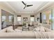 Inviting living room with tray ceilings, fan, and lots of natural light at 4789 Vasca Dr, Sarasota, FL 34240
