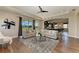 Comfortable living room with a view of the lake, and seamless flow to other areas at 4789 Vasca Dr, Sarasota, FL 34240