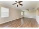 Large living room featuring wood-look flooring and natural light at 4789 Vasca Dr, Sarasota, FL 34240