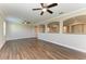 Spacious living room with arched wall cutouts and wood-look flooring at 4789 Vasca Dr, Sarasota, FL 34240