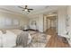 This is a spacious main bedroom with a ceiling fan, ensuite bathroom and seating area at 4789 Vasca Dr, Sarasota, FL 34240