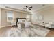 Main bedroom with tray ceiling, hardwood floors, and sitting area at 4789 Vasca Dr, Sarasota, FL 34240