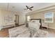 Main bedroom featuring tray ceiling, hardwood floors, and natural light at 4789 Vasca Dr, Sarasota, FL 34240