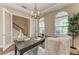 Bright home office showcasing French doors, abundant natural light, and an elegant chandelier at 4789 Vasca Dr, Sarasota, FL 34240