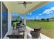 Relaxing covered patio with comfortable seating and a view of the expansive backyard at 4789 Vasca Dr, Sarasota, FL 34240