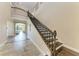 Grand foyer showcasing staircase with dark iron railing and wood steps at 4789 Vasca Dr, Sarasota, FL 34240