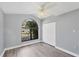 Bedroom featuring a large arched window, ample closet space, and neutral colors at 5047 82Nd E Way, Sarasota, FL 34243