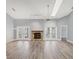 Spacious living room with a vaulted ceiling, stone fireplace, and French doors at 5047 82Nd E Way, Sarasota, FL 34243