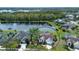Aerial view of home and community with lake and wooded area in the background at 5110 76Th E St, Bradenton, FL 34203