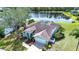 Aerial view of house with a pond and manicured lawn at 5110 76Th E St, Bradenton, FL 34203