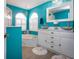 Bright bathroom with turquoise walls, vessel sinks, marble countertops and white shutters at 5110 76Th E St, Bradenton, FL 34203