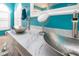 Bright turquoise bathroom with marble countertops, modern faucets, and vessel sinks at 5110 76Th E St, Bradenton, FL 34203