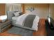 Comfortable bedroom showcasing a gray bed, decorative wall shelves, and modern furnishings at 5110 76Th E St, Bradenton, FL 34203