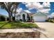 Charming one-story home with an attached two-car garage, front lawn, and mature landscaping at 5110 76Th E St, Bradenton, FL 34203