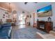 Open-concept living area with a fireplace, blue sofa, and dining area in the background at 5110 76Th E St, Bradenton, FL 34203