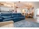 Expansive living area showcasing a blue sofa, fireplace, and adjacent dining space at 5110 76Th E St, Bradenton, FL 34203