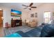 Relaxing living room featuring a fireplace, ceiling fan, comfortable seating, and stylish decor at 5110 76Th E St, Bradenton, FL 34203