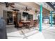 A covered outdoor living space with dining table, mounted television, and ceiling fans provides ample room to entertain at 5110 76Th E St, Bradenton, FL 34203