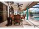 Entertain on this covered patio with outdoor seating, ceiling fans, and tv, overlooking the pool at 5110 76Th E St, Bradenton, FL 34203