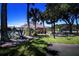 Community pool featuring lush landscaping, restroom facilities, picnic tables, and a tennis court at 5110 76Th E St, Bradenton, FL 34203