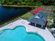 Aerial view of a community pool, tennis courts, lake, and covered seating area at 5110 76Th E St, Bradenton, FL 34203