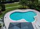 Aerial view of a community pool with ample deck space, lounge chairs, and lush landscaping at 5110 76Th E St, Bradenton, FL 34203