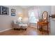 Sitting room with comfortable chair and ottoman, table and mirror with coral patterned curtains at 5110 76Th E St, Bradenton, FL 34203