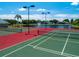The aerial perspective shows well-maintained tennis courts, with a tranquil lake and fountain in the background at 5110 76Th E St, Bradenton, FL 34203