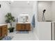 Well-lit bathroom featuring a single vanity, a large mirror, and a walk-in shower with modern finishes at 5142 Cote Du Rhone Way, Sarasota, FL 34238