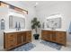 Elegant bathroom with double vanities featuring wood cabinetry, modern fixtures, and stylish mirrors at 5142 Cote Du Rhone Way, Sarasota, FL 34238