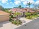 Beautiful home exterior with tile roof, arched entryway, and a brick paver driveway at 5142 Cote Du Rhone Way, Sarasota, FL 34238
