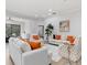 Spacious living room featuring bright sofas, stylish decor, and sliding glass doors to the lanai at 5142 Cote Du Rhone Way, Sarasota, FL 34238