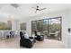 Bright living room with comfortable seating, ceiling fan, and views to the patio at 5142 Cote Du Rhone Way, Sarasota, FL 34238
