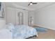 Spacious main bedroom with a ceiling fan, tray ceiling, and an arched entryway to an en-suite bathroom at 5142 Cote Du Rhone Way, Sarasota, FL 34238