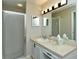 Clean bathroom featuring a shower, a vanity with a sink, and ample lighting at 5250 Hyland Hills Ave # 1514, Sarasota, FL 34241