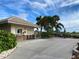 Community center near patio with tables and lush tropical landscaping under a beautiful sky at 5250 Hyland Hills Ave # 1514, Sarasota, FL 34241