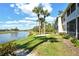 Beautiful building exterior set against a lake; serene and inviting at 5250 Hyland Hills Ave # 1514, Sarasota, FL 34241