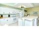 Bright kitchen featuring white appliances, countertops and cabinetry provides ample space and functionality at 5250 Hyland Hills Ave # 1514, Sarasota, FL 34241