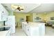 Kitchen with white cabinets, appliances, and countertops offering views into the adjacent living spaces at 5250 Hyland Hills Ave # 1514, Sarasota, FL 34241